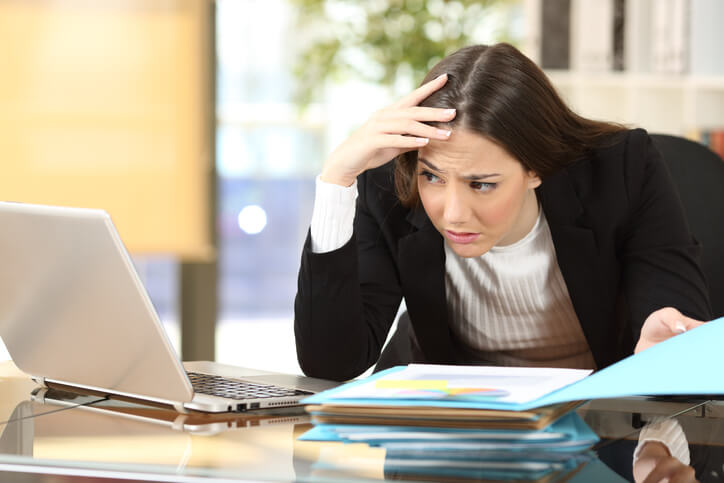 Worried businesswoman with a difficult job watching her laptop on line in a desk at office